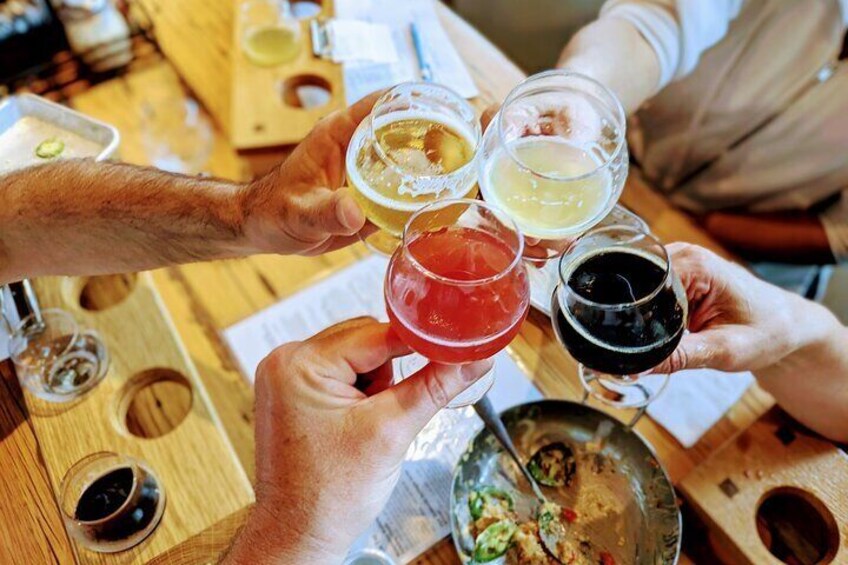 Guests cheers with different beers at Mountains Walking Brewery on the Bozeman Brewery Hop