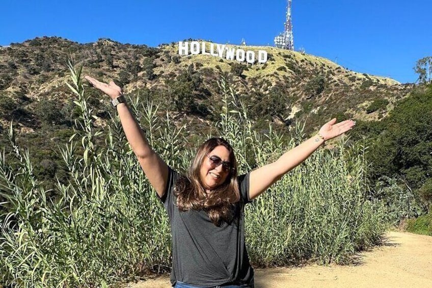 A woman in front of Hollywood Sign at Los Angeles