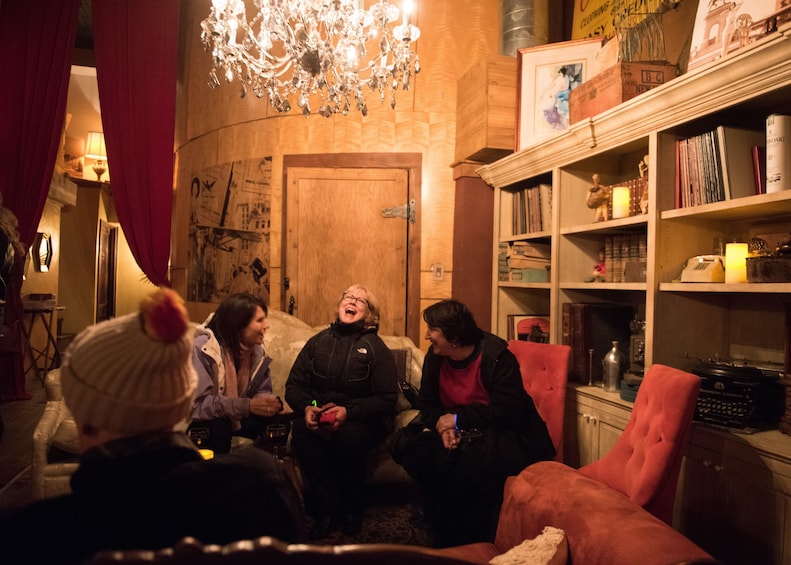 Group sitting and enjoying drinks on the Haunted Pub Tour in San Antonio 