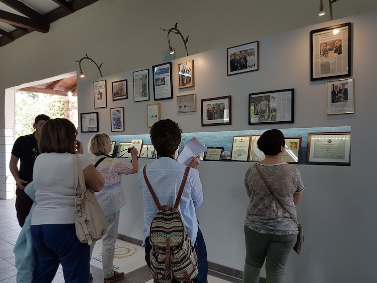 Tour group looking at pictures on a wall in Corfu