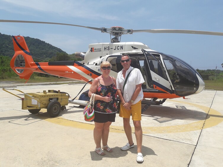 Couple next to helicopter in Phuket