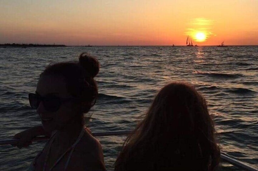 Girls on the bow watching sunset near Egmont Key