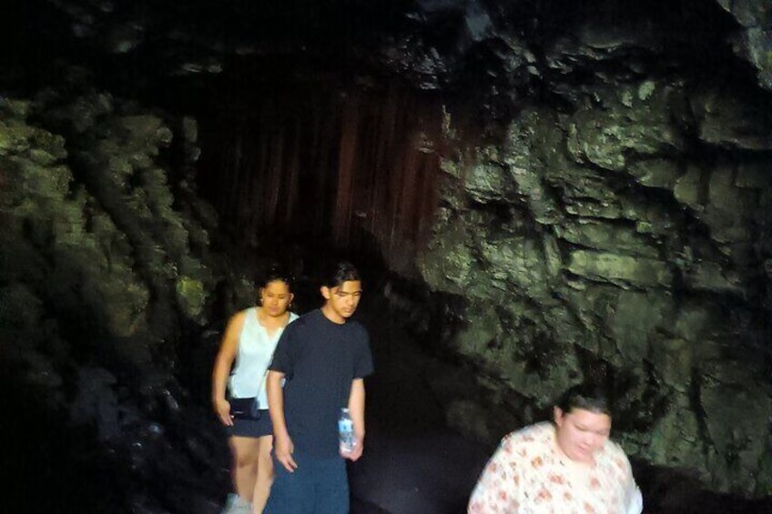 Lava Tube in Hilo Hawaii with olivine a green gem stone on the ceiling. 