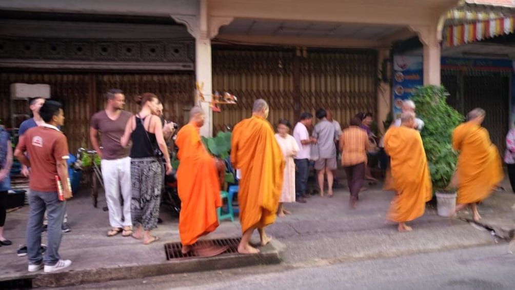 Tour group and monks in Takuapa Old Town
