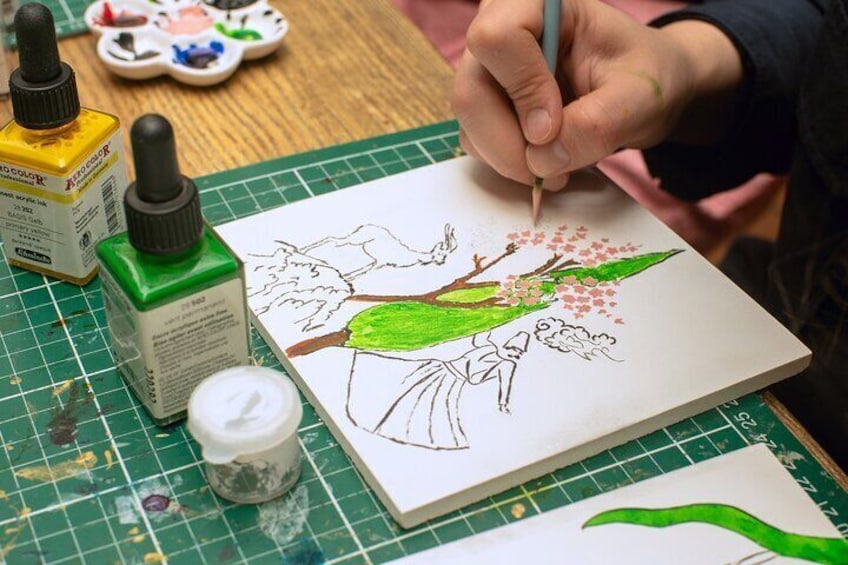 Adding intricate details to a traditional Turkish tile design during the workshop.