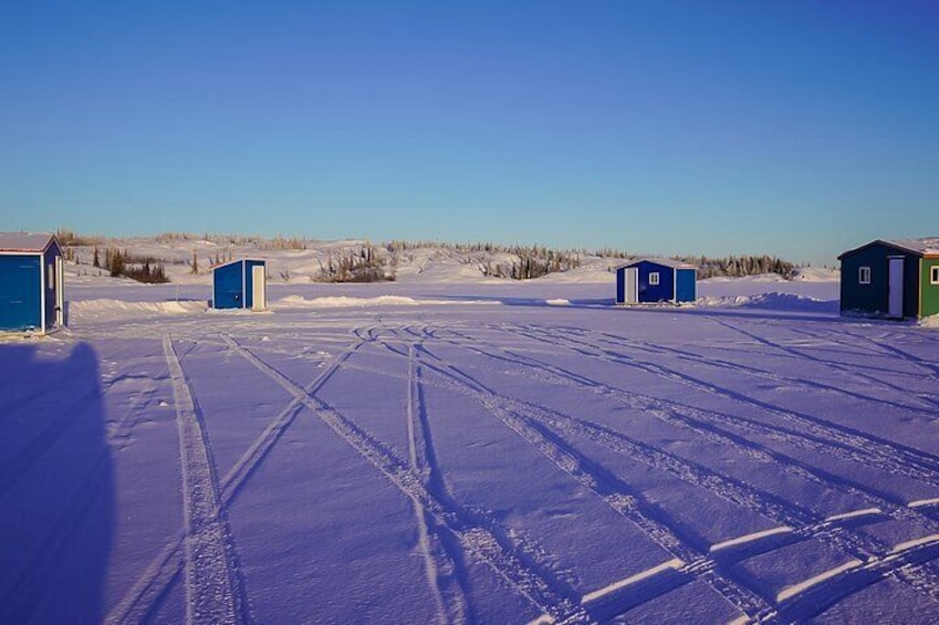 Arctic ice fishing camp during the day