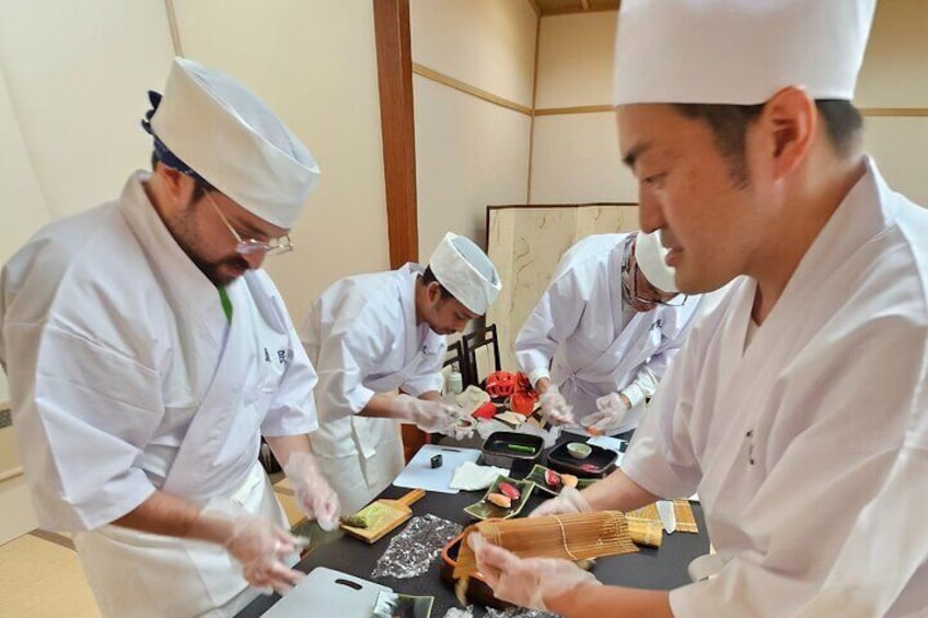 The chef is teaching how to make sushi.