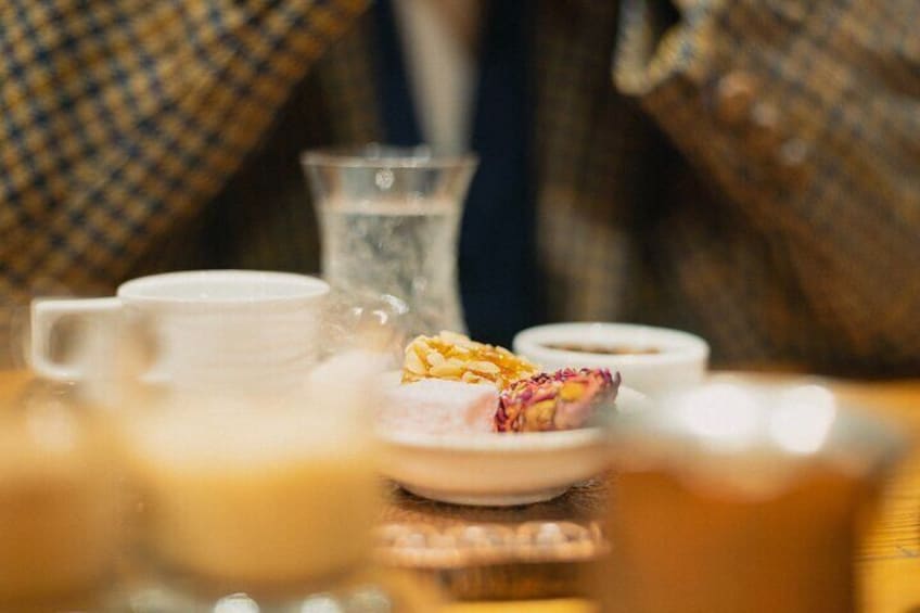 Close-up of traditional Turkish coffee and sweet treats served during the workshop.