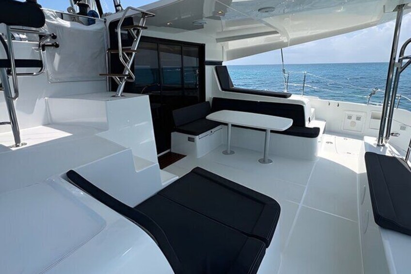 The catamaran’s stylish and modern outdoor seating area, designed for comfort and relaxation