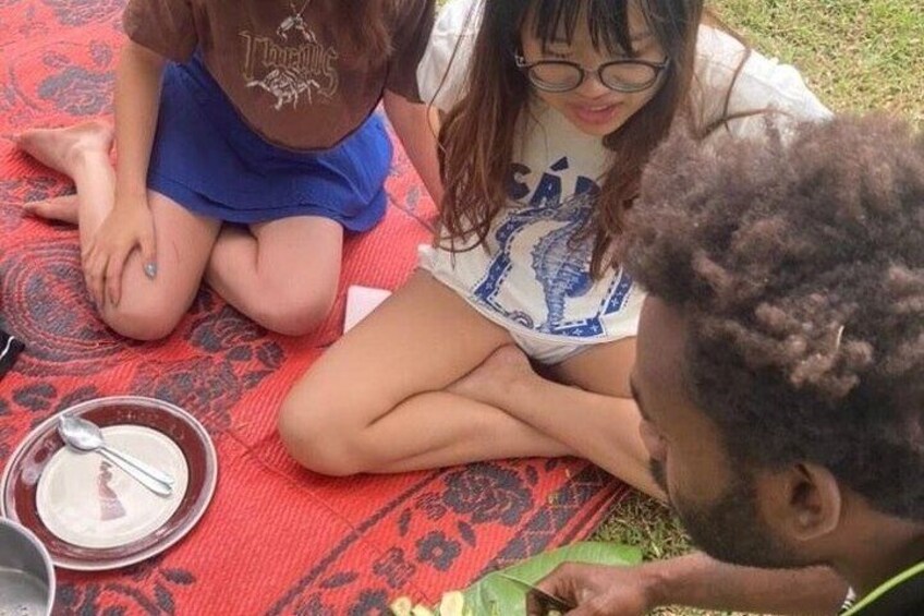 Tourists learning to cook dinner at Mele Village