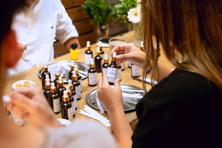 Participants engaged in selecting and mixing fragrance oils during the Istanbul perfume making workshop