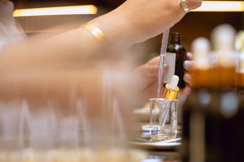 Close-up of a participant carefully blending scents in the Istanbul perfume making workshop