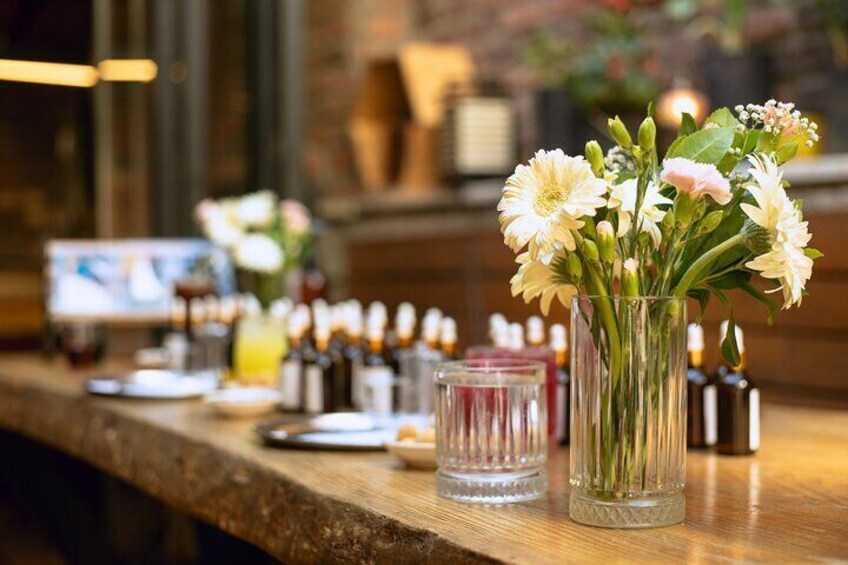 A beautifully arranged workshop table with flowers and fragrance oils, enhancing the perfume making experience in Istanbul