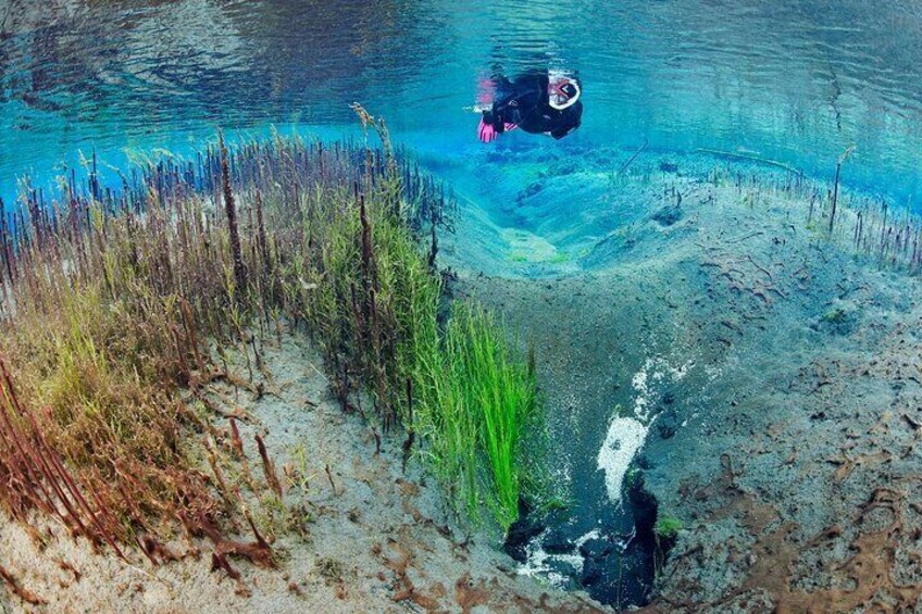 Snorkeling over bubbling sands in Litlaá river near Húsavík in north Iceland