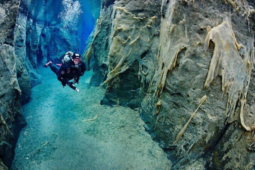 Diver in Nesgjá fissure on the Diamond circle in North Iceland