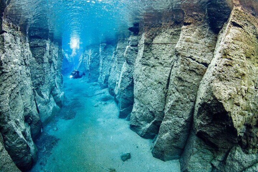 A diver in Nesgjá fissure, sometimes called the Silfra of the North