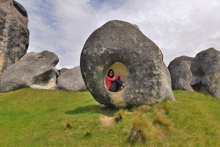 Lady sitting in boulder at Castle Hill Rocks