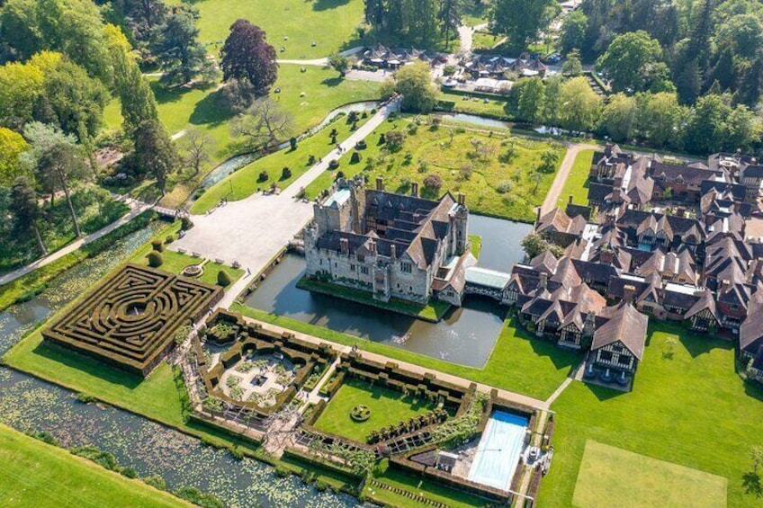 Aerial view of Hever Castle’s meticulously maintained gardens, with its famous yew maze and scenic moat, reflecting the grandeur and history of the estate.