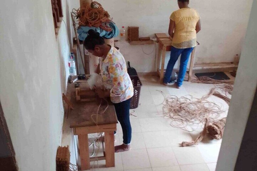 Working ladies are making - 100% natural scrubber for kitchen and bathroom - cleaning mat at the 1st stage manufauring process