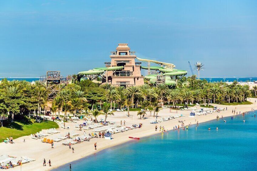 Experience the stunning architecture and lush landscapes of Atlantis Aquaventure, with thrilling rides overlooking the pristine beach.