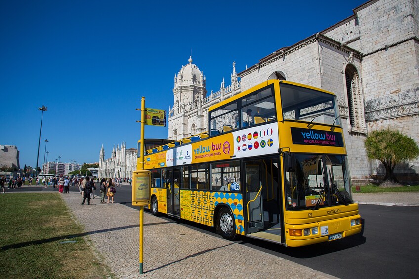 Hop-On Hop-Off tour bus in front of the Jerónimos Monastery in Belém