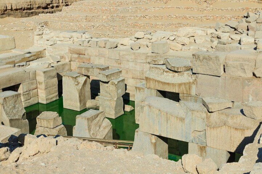 A photo of the Osireion in Abydos, Egypt, showcasing the underground structure with its columns and the pool of water.