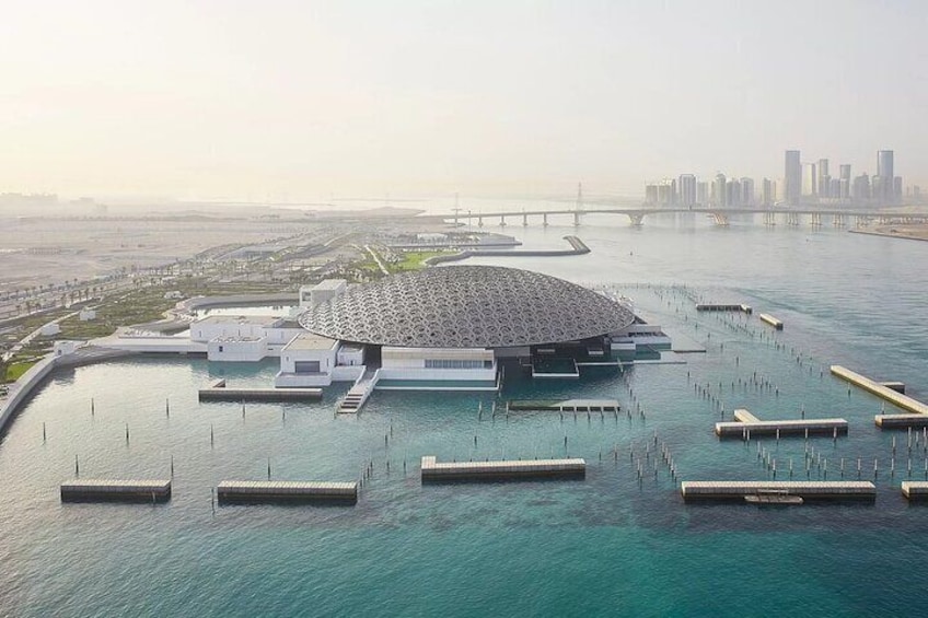 The Louvre Abu Dhabi, an architectural marvel set amidst the tranquil waters of the Arabian Gulf, offers a cultural oasis with panoramic city views.
