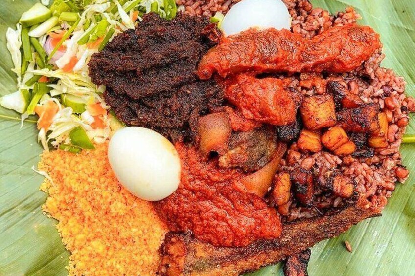 "Waakye, the quintessential Ghanaian dish, served with a delectable mix of boiled eggs, fried plantain, fried fish, garri, and salad. An explosion of flavors in every bite! ️ #Waakye #GhanaianEats