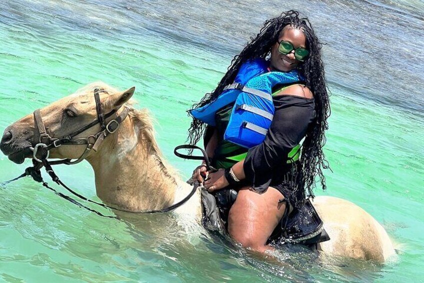 Horse back ride and swim in the crystal clear waters in f Montego Bay Jamaica.