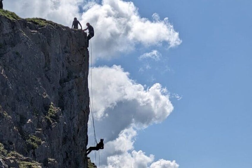 Silhouetted abseilers at Uphill Quarry