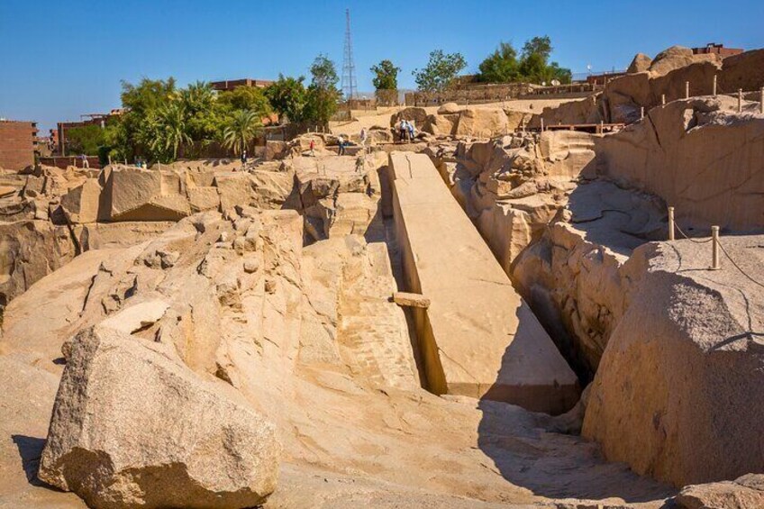 A close-up view of the Unfinished Obelisk, the largest known ancient obelisk, showcasing its massive size and the intricate carvings on its surface.