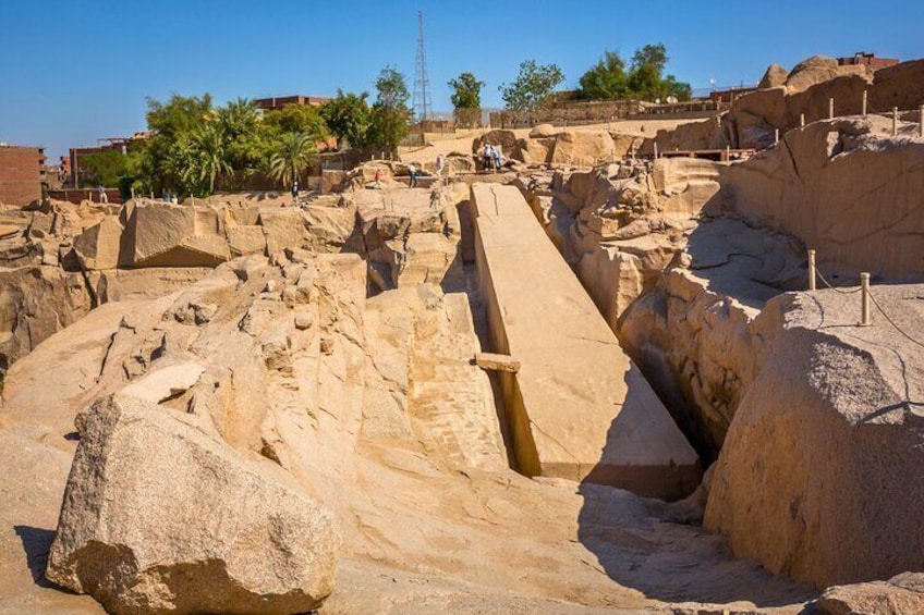 A close-up view of the Unfinished Obelisk, the largest known ancient obelisk, showcasing its massive size and the intricate carvings on its surface.