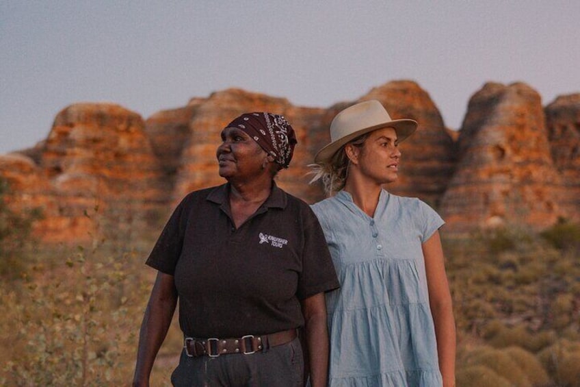 Kingfisher tours head guide Rebecca Sampi and guest in front of the beehive domes