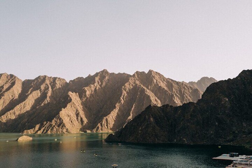 A tranquil scene of Hatta Dam, with the towering Hajar Mountains providing a stunning backdrop.