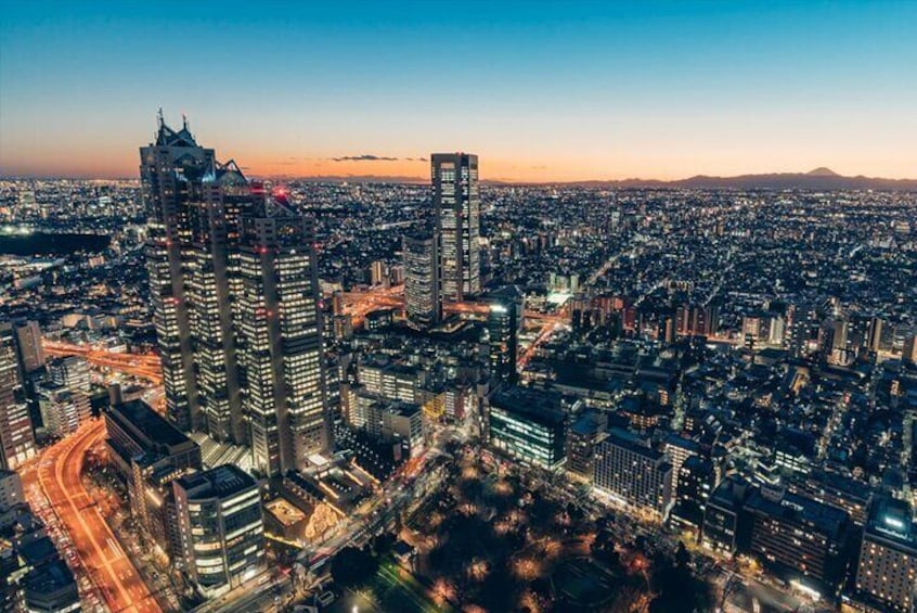 Watch the sky transform with vibrant colors as you enjoy a stunning Tokyo sunset from above.