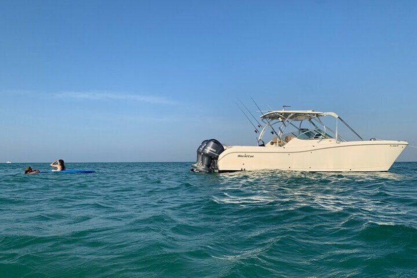 two passengers lounge our a float behind our boat at Egmont Key Florida