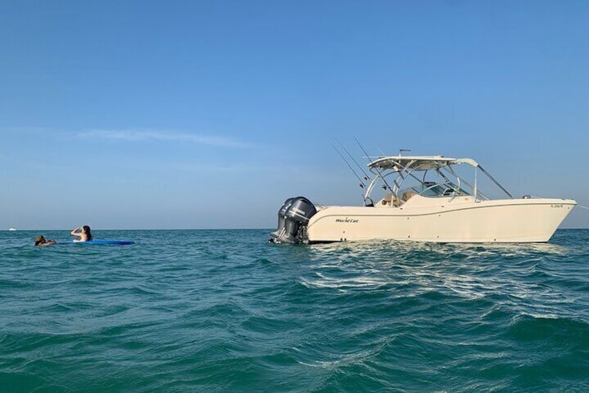two passengers lounge our a float behind our boat at Egmont Key Florida