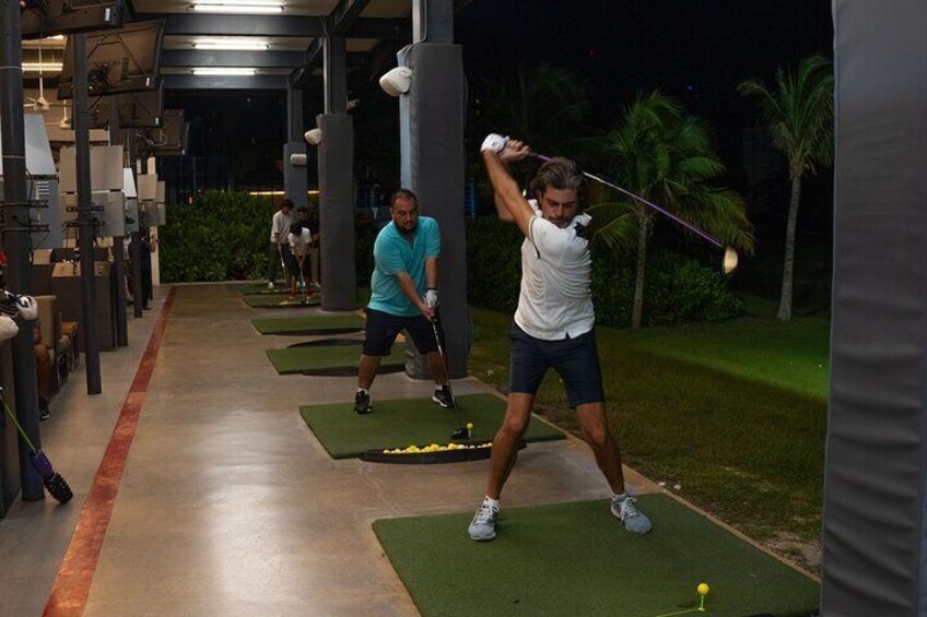 Experience the thrill of night golf with friends, perfecting your swing under the stars in our high-tech Toptracer bays