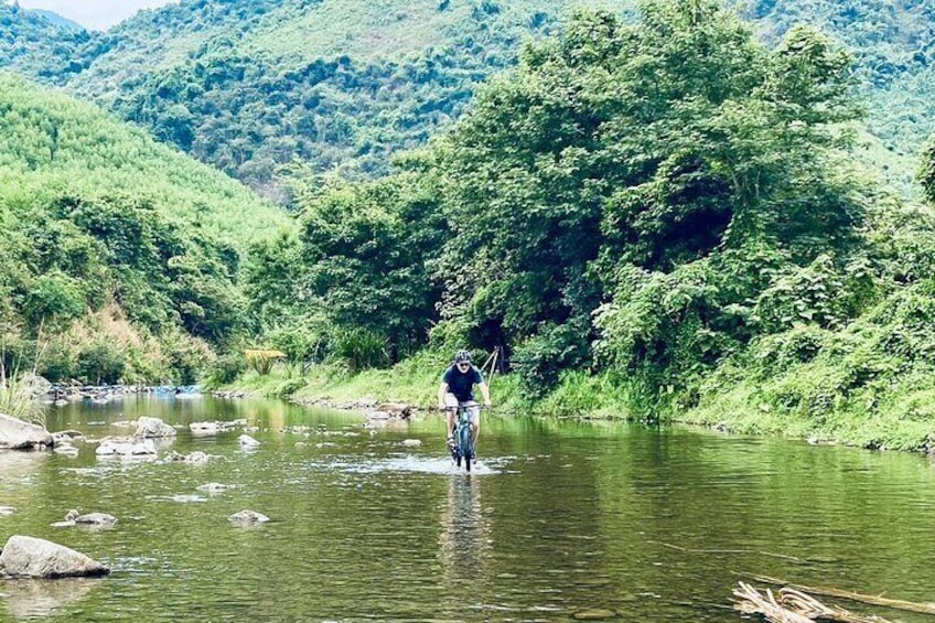 Cycle across a small stream to reach Mơ stream - Da Nang countryside bike tour