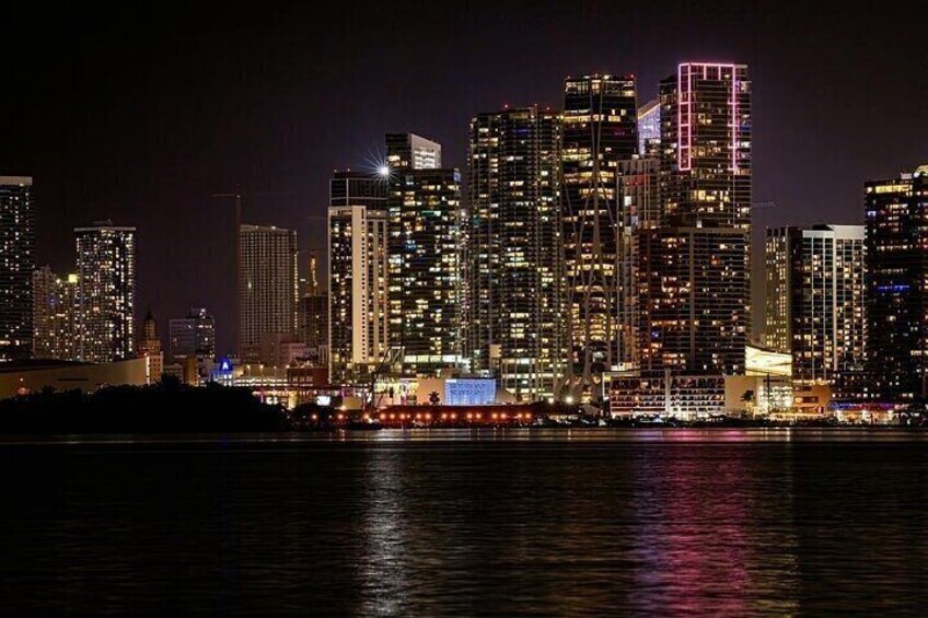 The stunning city lights of Miami seen from our pirate ship, a magical view of the night.