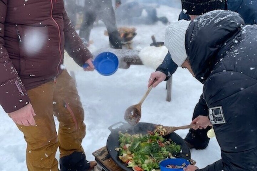 Serving lunch over open fire.