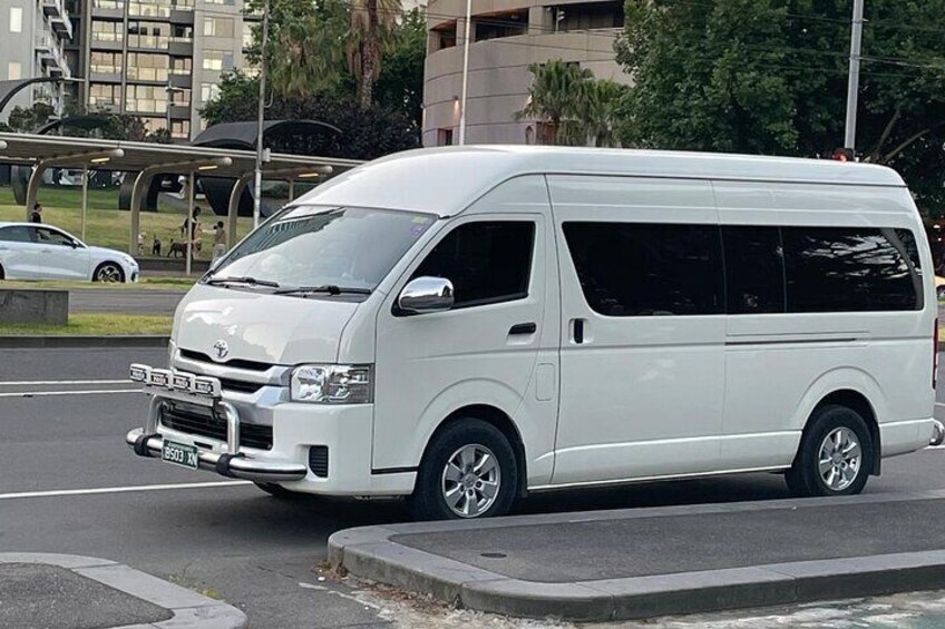 A sleek Toyota Hiace parked amidst the modern charm of a Mornington Peninsula winery, ready for a scenic adventure.