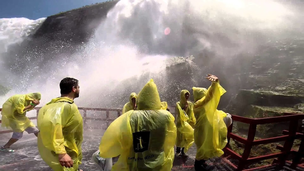 Guests wearing yellow ponchos while enjoying the tour of the American side of Niagara Falls

