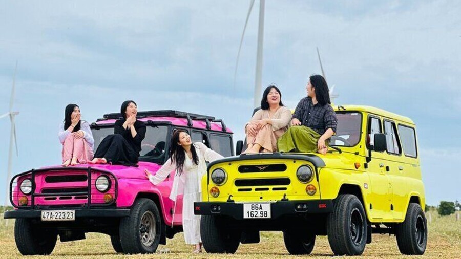 Tourists take photos with jeeps