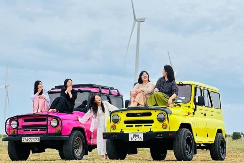 Tourists take photos with jeeps