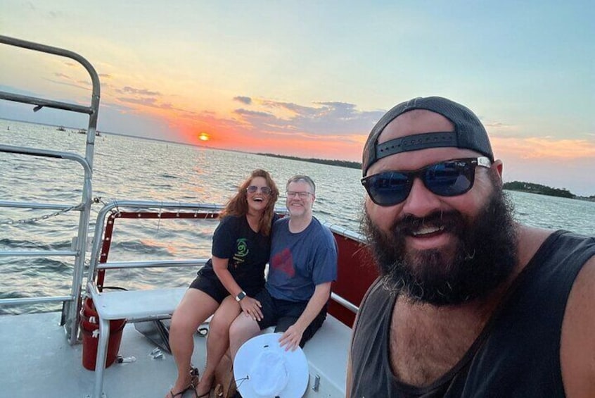 Captain Morgan with cruisers watching the sunset aboard the SunVenture catamaran.