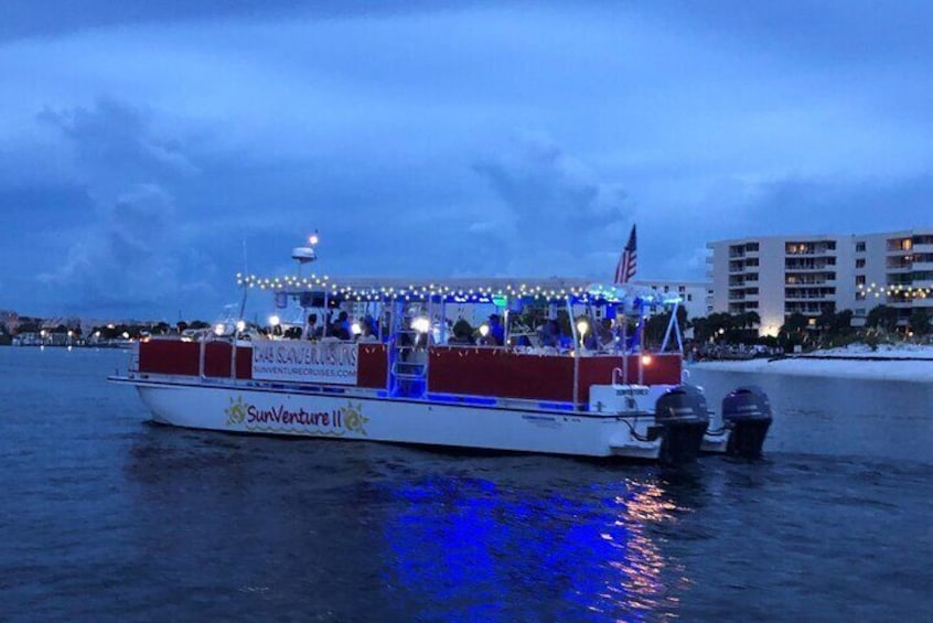 SunVenture catamaran cruising the bay during a Sunset, Dolphin, & Holiday Lights Cruise. 