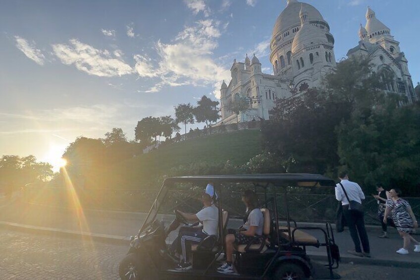Watching the sunset from a unique perspective! Enjoy an unforgettable evening ride by Sacré-Cœur as the sun dips below the Paris skyline, bathing the city in a golden glow."