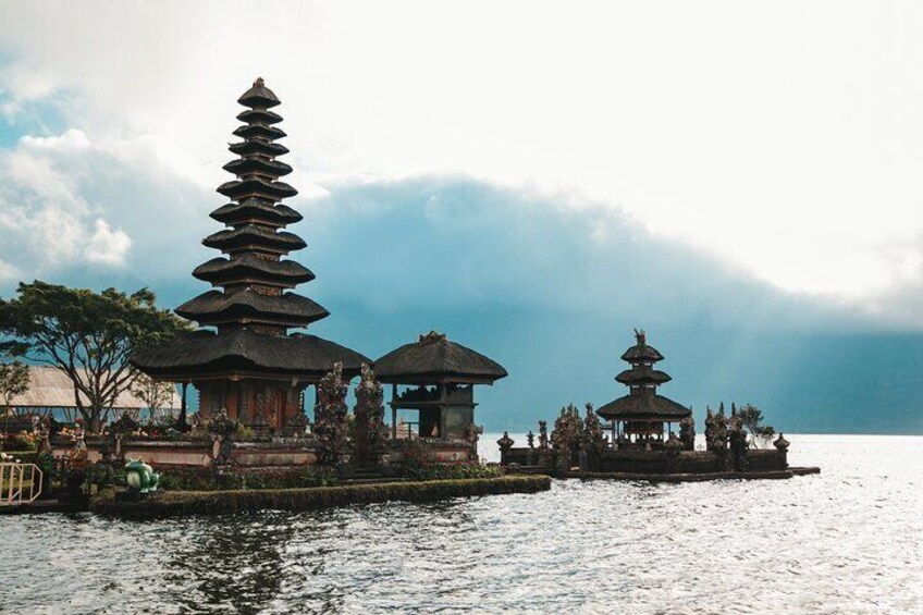 Beratan Lake in Bedugul: A serene lake surrounded by lush hills, featuring the iconic Ulun Danu Beratan Temple, which appears to float on the water.