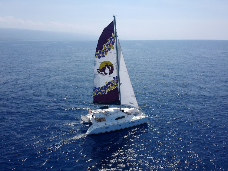 Serene views of a yacht sailing along the Kona Coast 